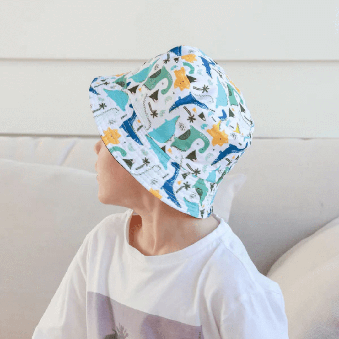 Stewarts Menswear Free Spirit Australia Kids Bucket Hat. Light coloured hat featuring a fun dinosaur print all over.