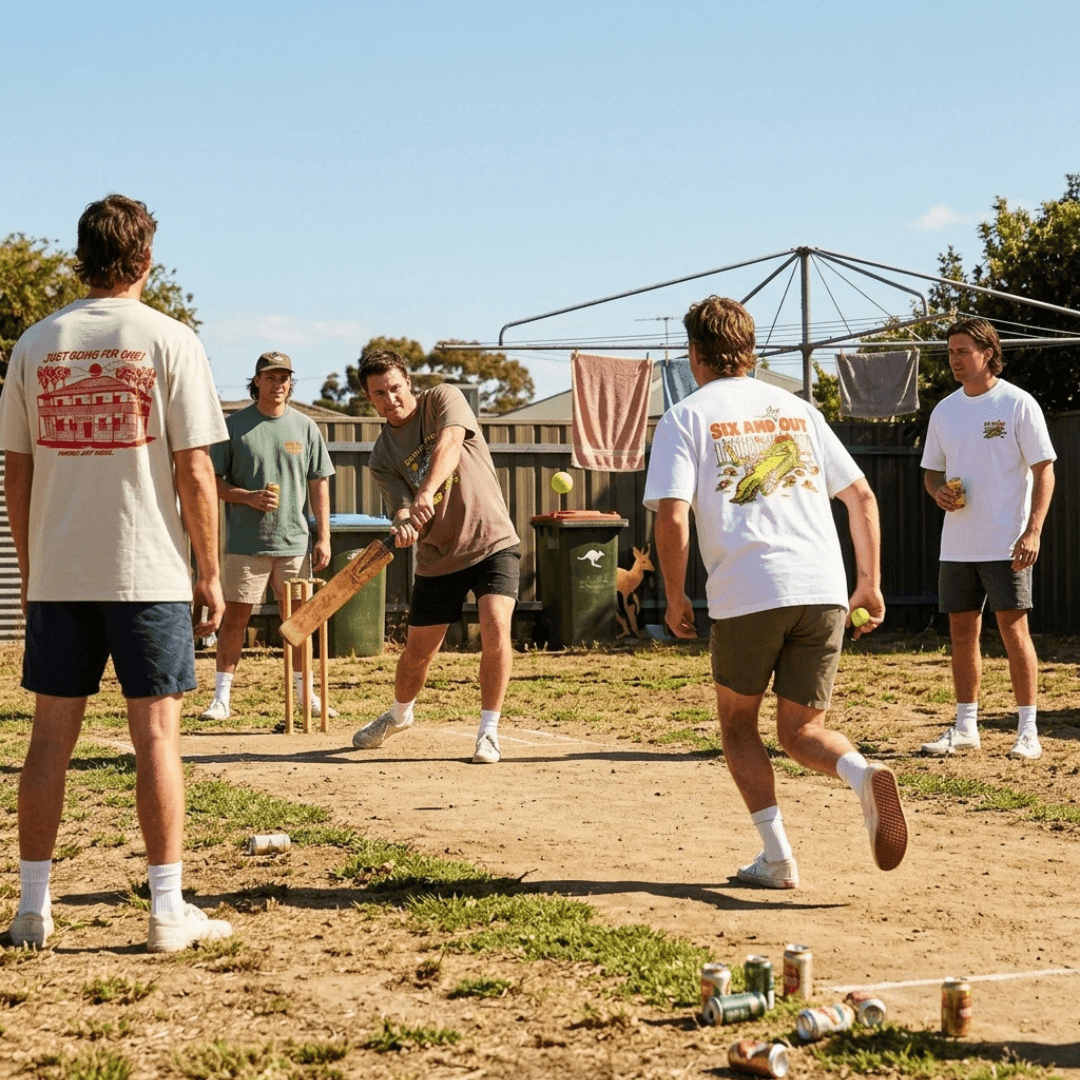 A group of young men playing cricket outdoors in a backyard. Several players are wearing graphic t-shirts from General Store Merchandise available from Stewart's Menswear, Mullumbimby