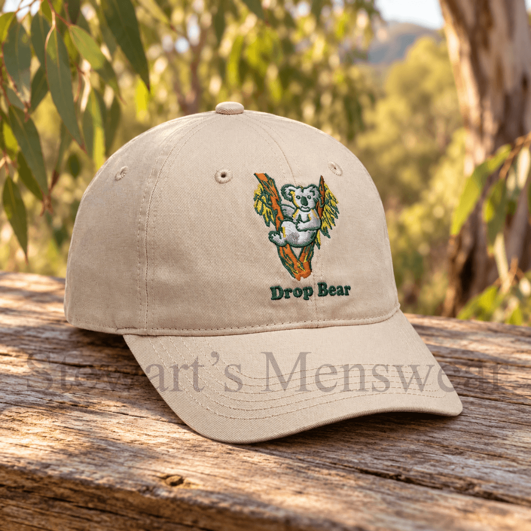 Drop Bear Cap in stone, a 6-panel cap with an embroidered koala in a gum tree and Drop Bear lettering, available at Stewart's Menswear Mullumbimby.