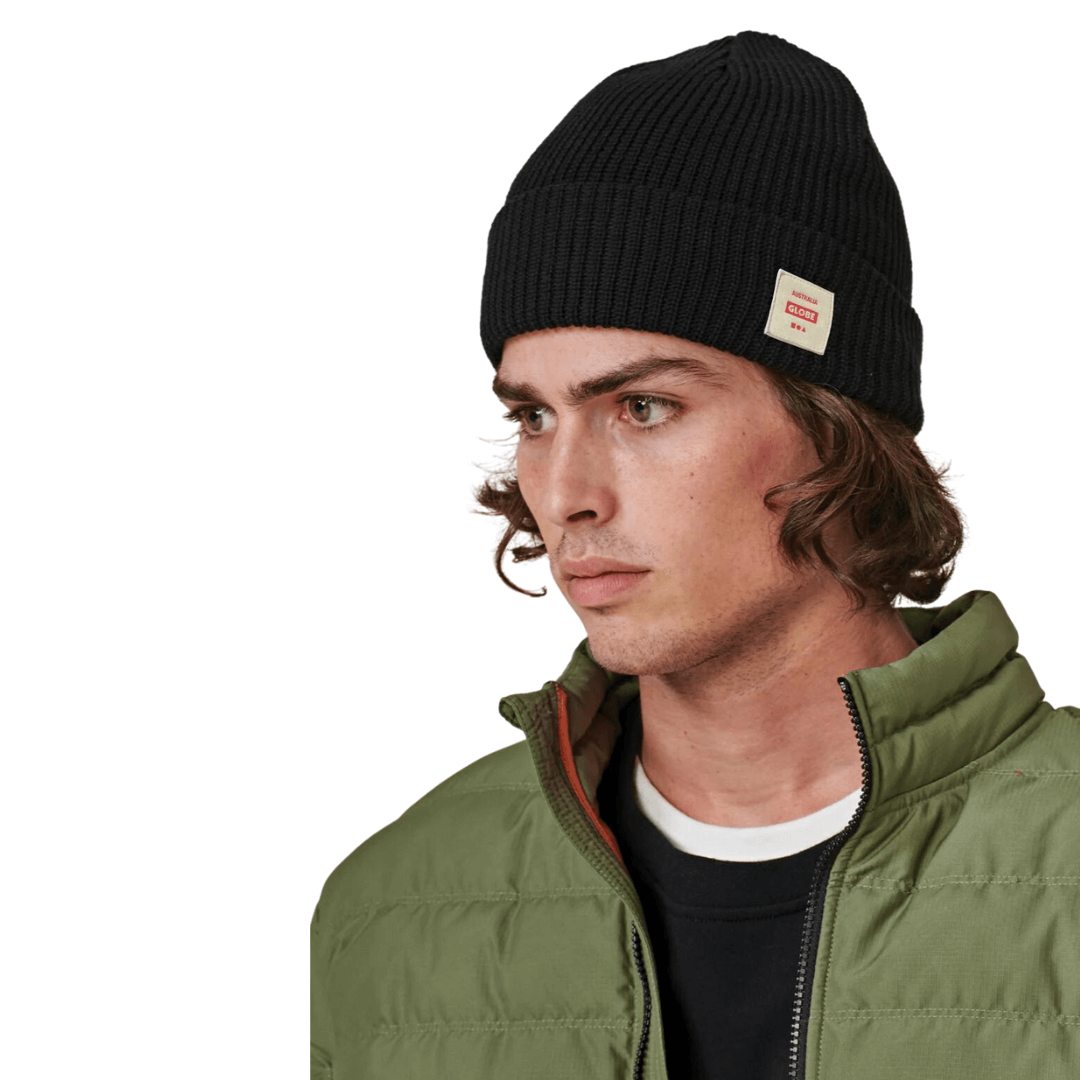 Stewarts Menswear Globe Sustain organic cotton beanie. The Globe Sustain Beanie is an all-round beanie that combines comfort, durability, and eco-aware craftsmanship. Made with 100% organic cotton and featuring a 1x1 chunky knit double layer construction, this beanie is not only trendy but also a sustainable choice. Model is wearing black beanie.