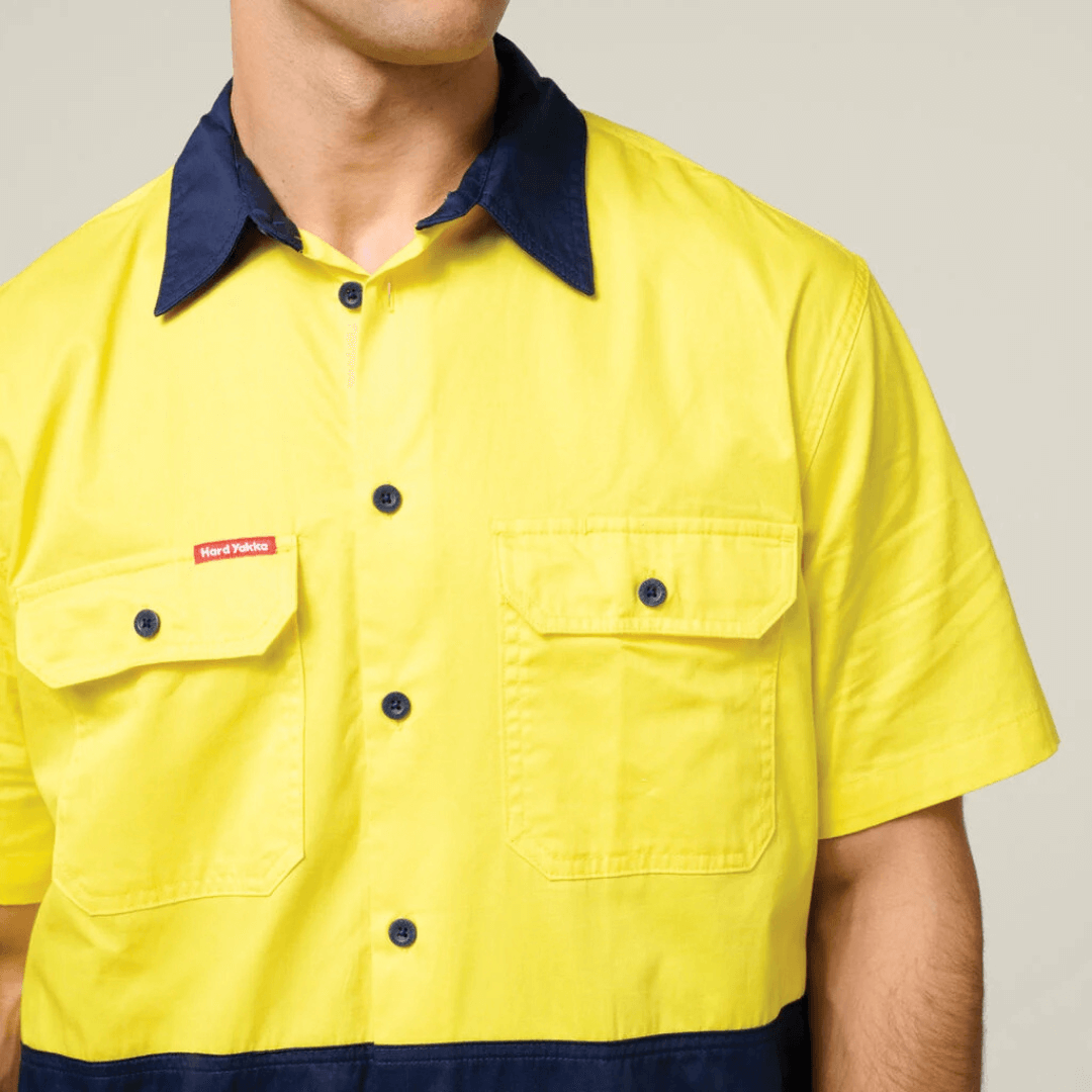Close up front view of Hard Yakka Core Hi-Vis Lightweight Vented Short Sleeve Cotton Drill Shirt UPF 50+ with chest pockets, available at Stewart’s Menswear Mullumbimby. Y04620