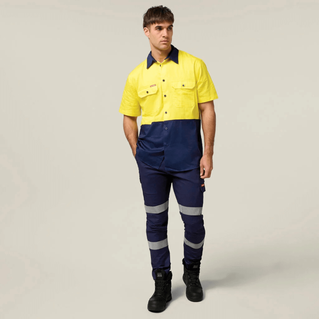 Model wearing Hard Yakka Core Hi-Vis Lightweight Vented Short Sleeve Cotton Drill Shirt UPF 50+ with chest pockets, available at Stewart’s Menswear Mullumbimby. Y04620