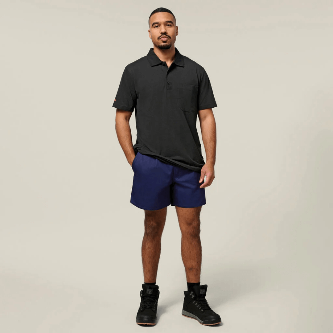 Model wearing Navy coloured Hard Yakka relaxed fit cotton drill shorts with side tabs available from Stewart's Menswear, Mullumbimby.