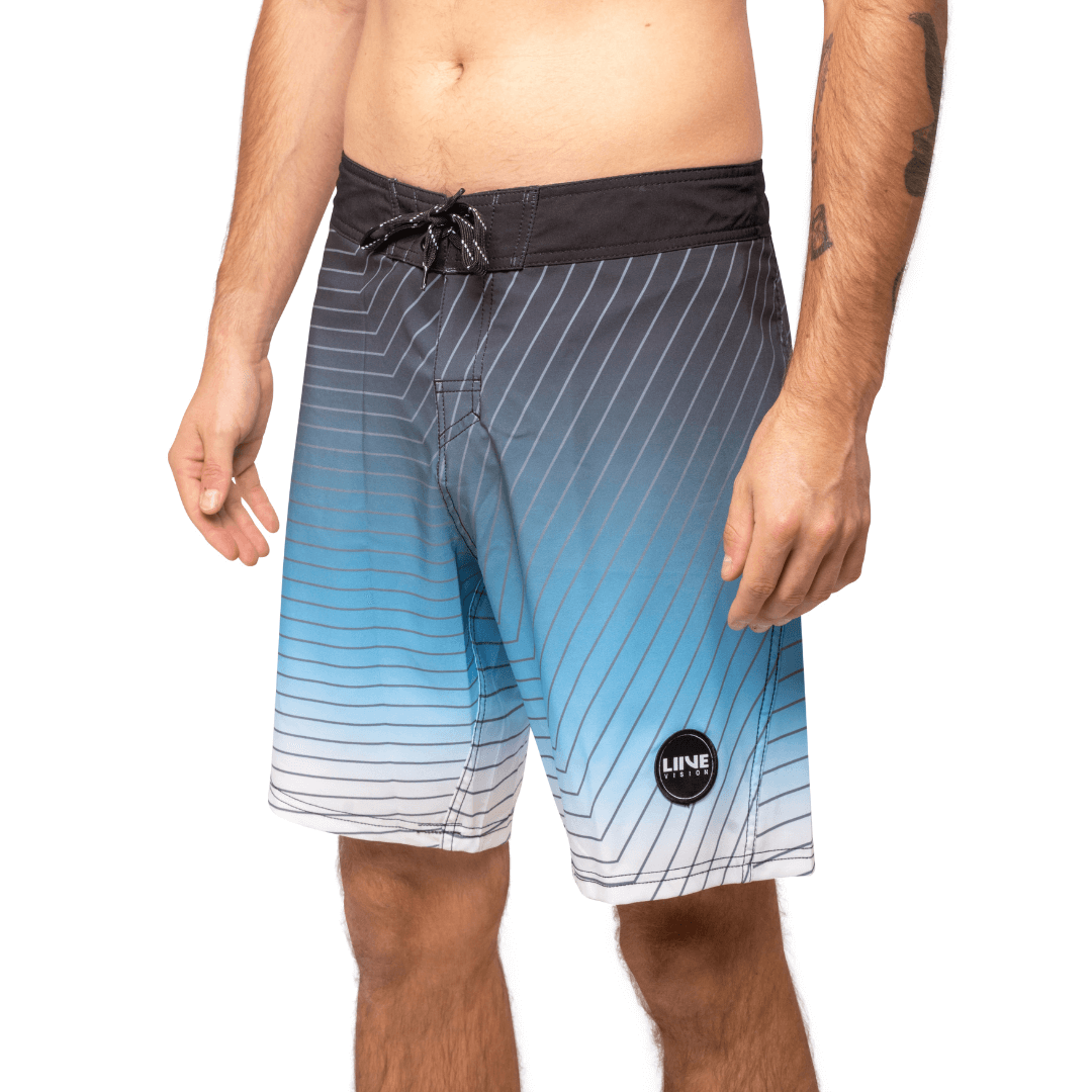 Stewarts Menswear Liive Apparel Cartesian Boardshort. Fitted waist with drawcord, back patch pocket with velcro closure and key loop in the back pocket. Charcoal waistband. Trendy gradient colour design in blue/white shades with charcoal stripe all over. Front View.