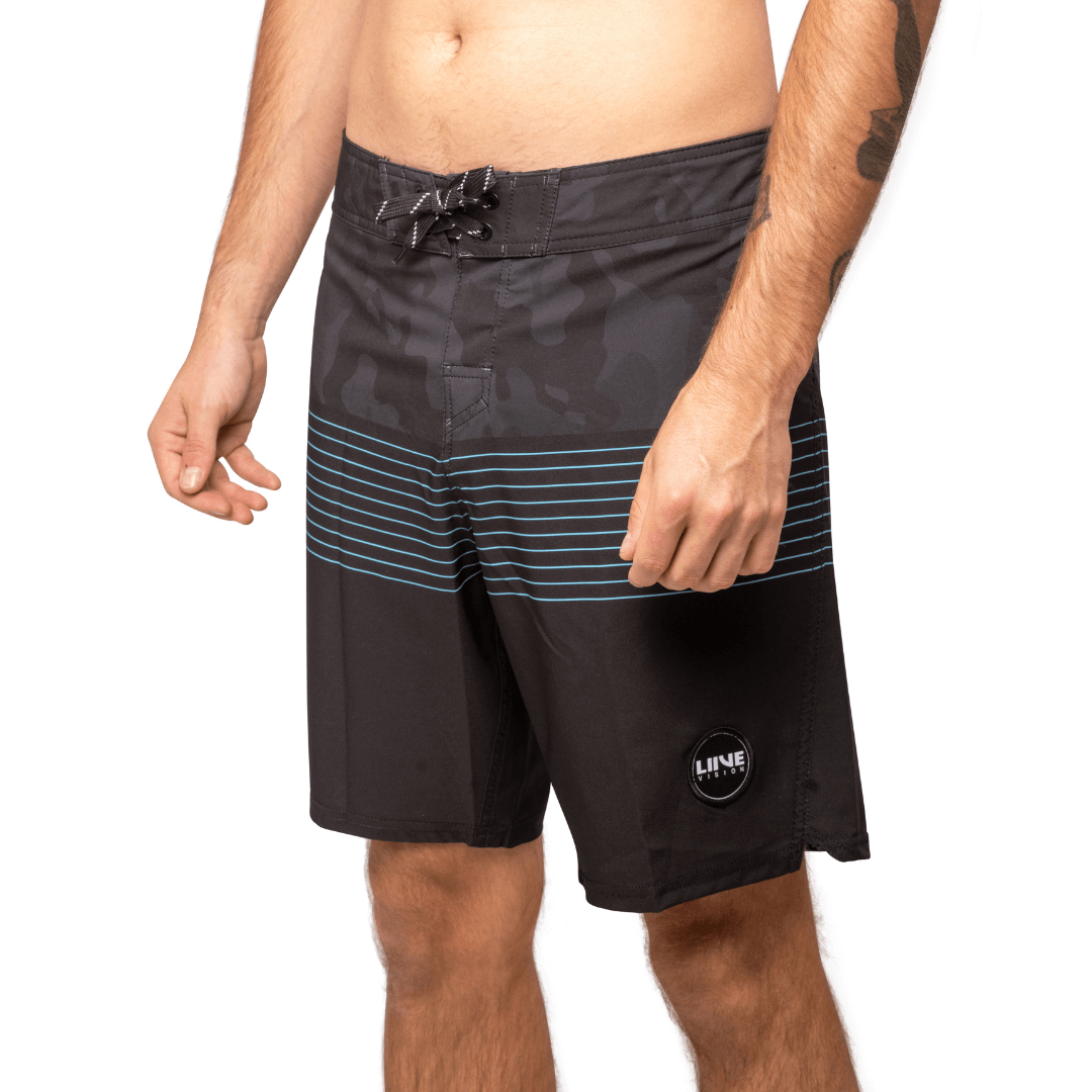 Stewarts Menswear Liive Vision Apparel. Revival Boardshort. Black Camo colour block and top and black colour block at bottom with blue stripes through mid-section. Fitted waist with drawcord, back patch pocket with velcro closure and key loop in the back pocket. Back View.