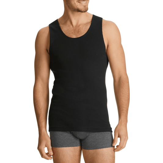 Man wearing a black chesty bond singlet and gray underwear on a white background. Bonds Chesty Bond Singlet available at Stewart’s Menswear Mullumbimby in ribbed cotton with classic men’s styling.