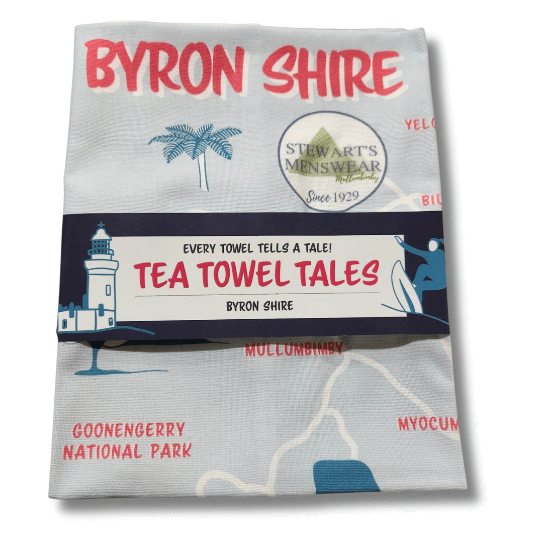 Stewart's Menswear souvenir Byron Shire tea towel. Check out these Byron Shire souvenir tea towels which are made from 100% cotton and designed and printed locally in Tweed Heads, the perfect way to remember your visit to Mullumbimby. Featuring many of the towns in the Byron Shire placed on a rough map with a small charicature of an iconic landmark in each town. Stewart's Menswear logo also features above the Middle Pub icon in Mullumbimby. This photo shows the packaged view of the tea towel.