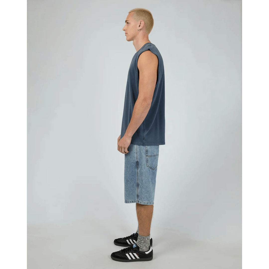 Man wearing Silent Theory basics classic muscle tee available from Stewart's Menswear in Mullumbimby. Pigment washed, navy colour,  side view.