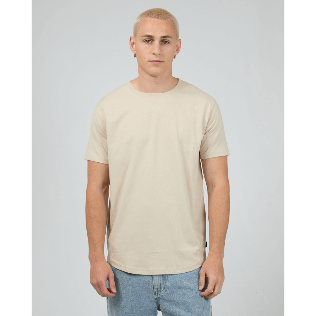 Stewart's Menswear, Mullumbimby. Product photo of model wearing Silent Theory Solid Tail Tee. Colour is Tan