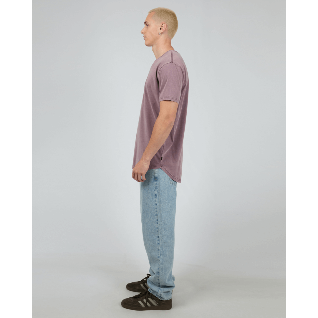 Stewarts Menswear, Mullumbimby. Photo shows model wearing  vino coloured Silent Theory Tail Tee, side view.