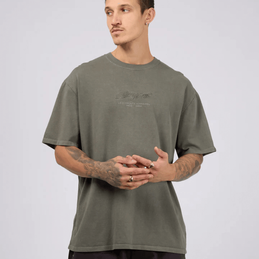 Model wearing St Goliath Arching tee available from Stewarts Menswear in Mullumbimby.