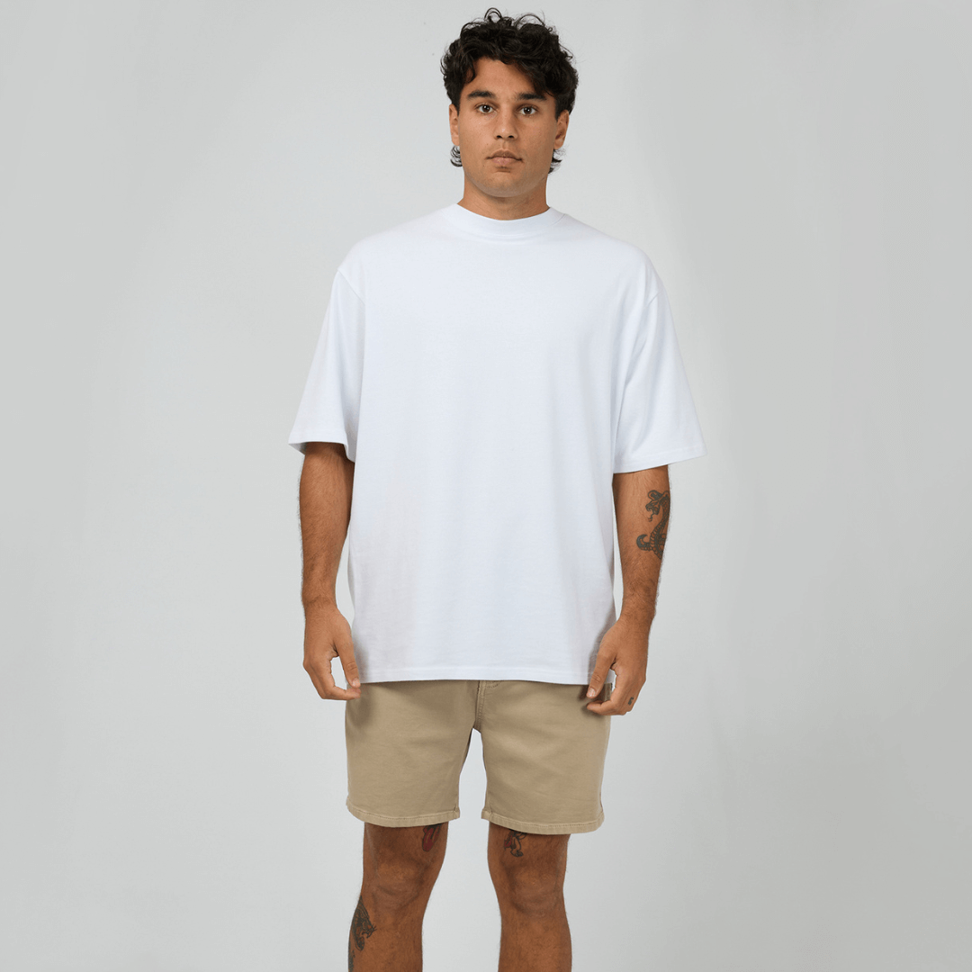 St Goliath Constructed Fairhaven Shorts available at Stewart’s Menswear Mullumbimby. Hybrid denim shorts with fitted waistband and subtle logo. Front  view of sand coloured constructed Fairhaven shorts.