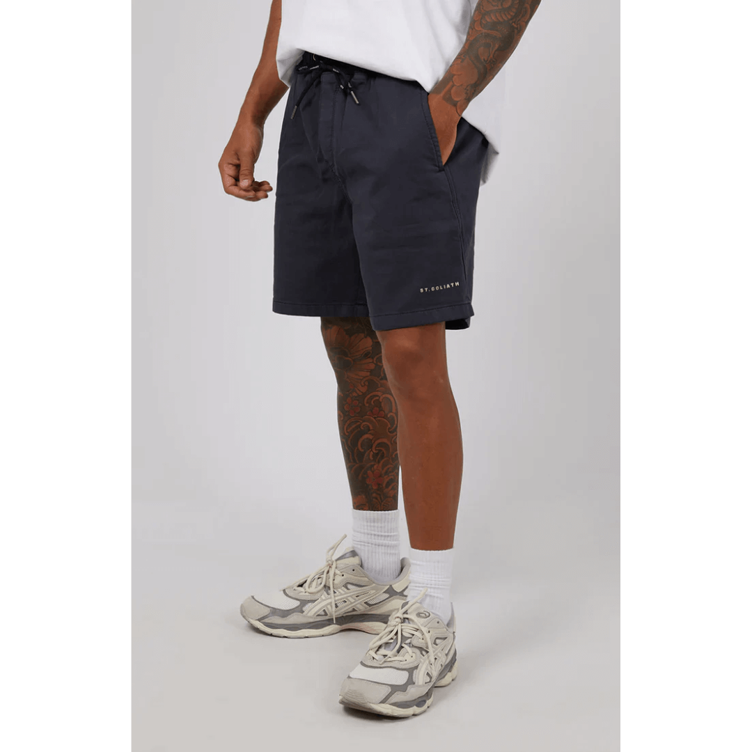 Stewart's Menswear, Mullumbimby. Model wearing St Goliath Fairhaven short in Navy. St. Goliath logo on leg.
