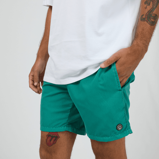 St Goliath Illusion Short available at Stewart's Menswear in Mullumbimby. Photo shows model wearing Tide Green colour St Goliath Illusion Shorts.