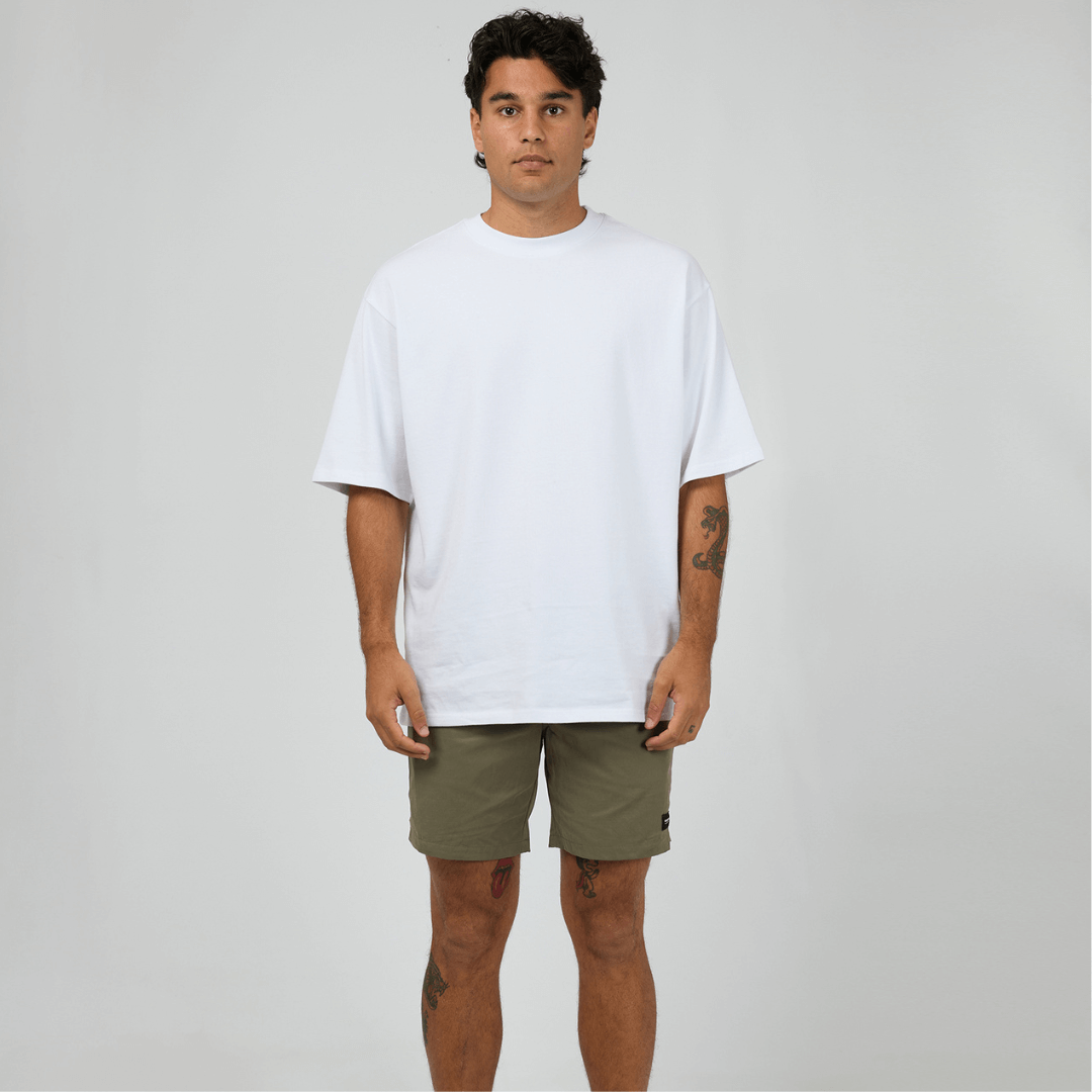 St Goliath Swim Volley Short available at Stewart’s Menswear Mullumbimby. Men’s modern fit swim short with stretch nylon, Velcro back pocket, and branded patch. Photo shows front view, colour is Olive