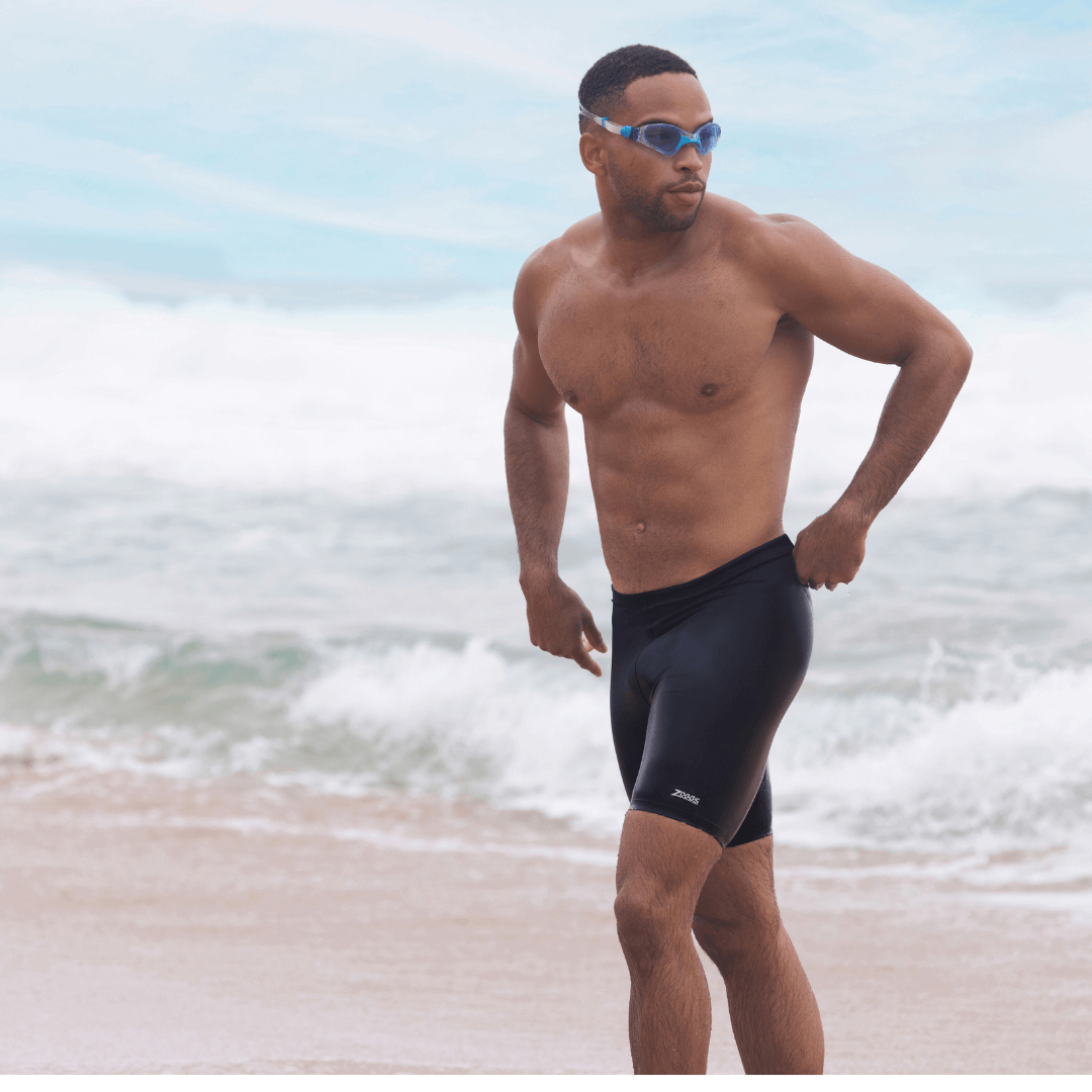Stewarts Menswear, Mullumbimby. Lifestyle Photo of model wearing Zoggs Cottesloe Mid Jammer at the beach