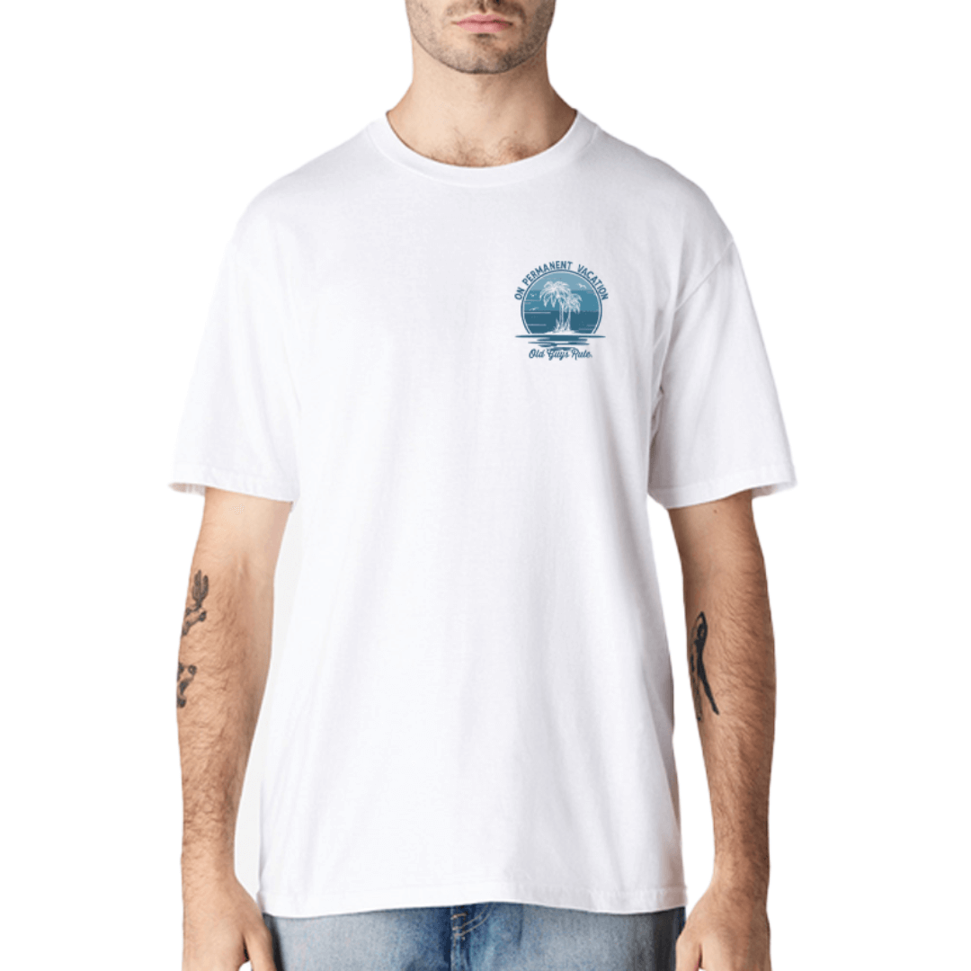 Stewart's Menswear, Mullumbimby. Old Guys Rule T-shirt. Photo shows model wearing Old Guys Rule On Permanent Vacation T-shirt, front view. White T-shirt with small chest print blue palm tree design "On Permanent Vacation"