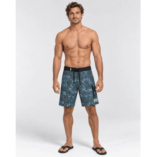 Model wearing Outback Supply Co black with blue  leaf print boardshorts with high waist and back pocket, available at Stewart's Menswear Mullumbimby.