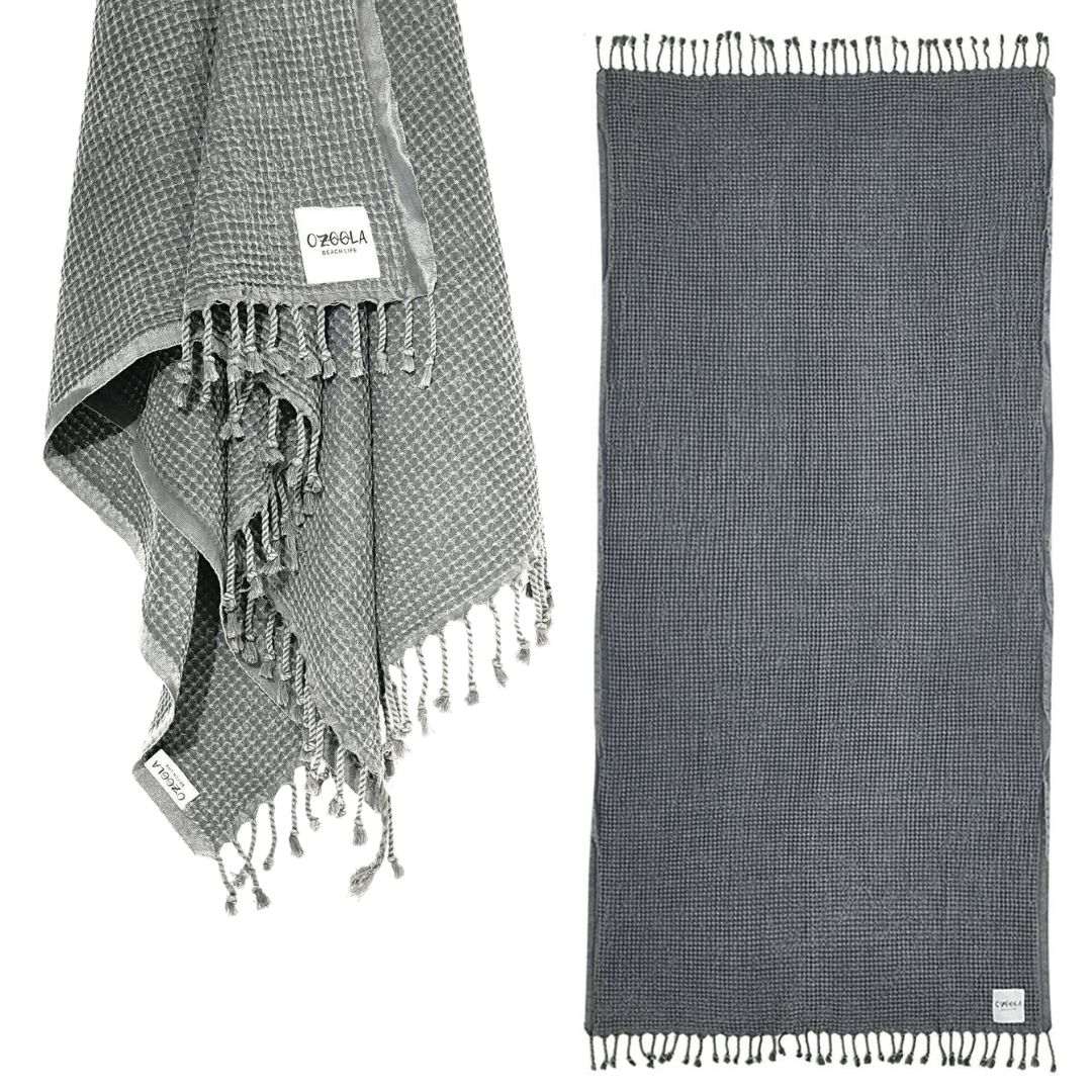 Stewarts Menswear Ozoola Waffle Beach Towel. The Ozoola Waffle Beach Towel is made from 100% Turkish Cotton which is super absorbent and extremely fast drying.  Sized at 170 x 185cm with knotted fringing at each end. Colour is Charcoal.
