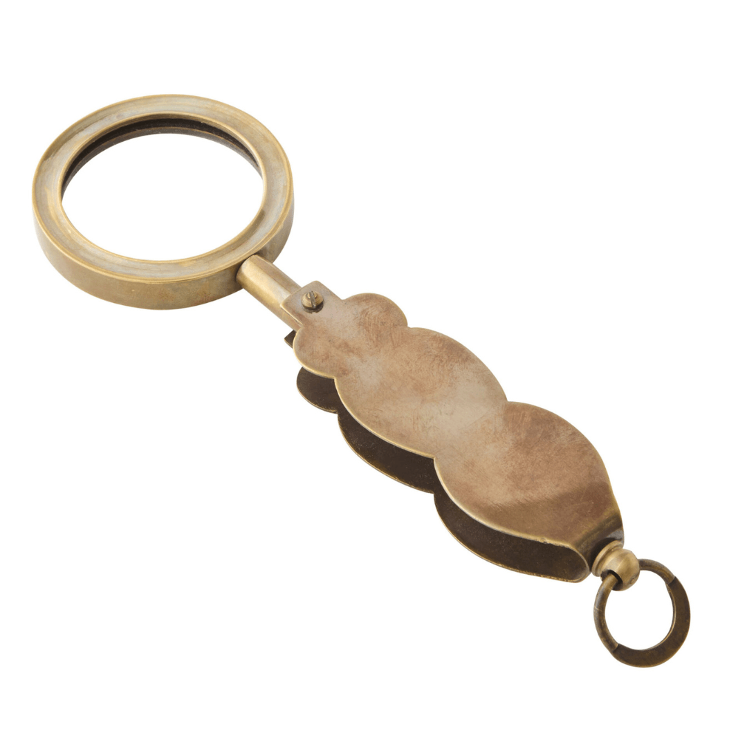 Handmade Folding Magnifier in brass and glass with a folding pocket design, available at Stewart's Menswear Mullumbimby. Shown opened out.