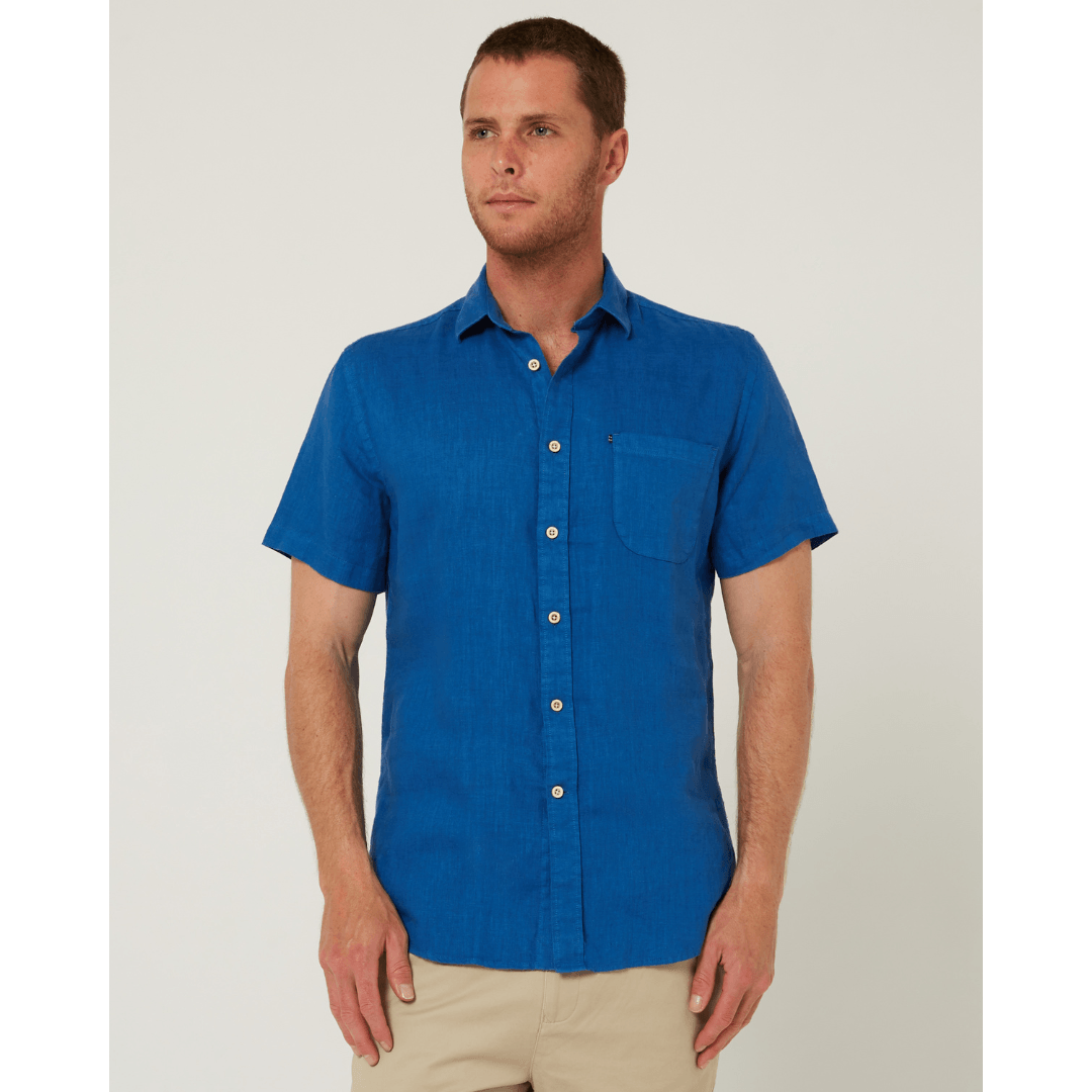Model wearing men's Pilbara Collection by Ritemate Workwear Classic Fit Short Sleeve Linen Shirt in deep blue with Windmill embroidery detail, available at Stewart's Menswear Mullumbimby.