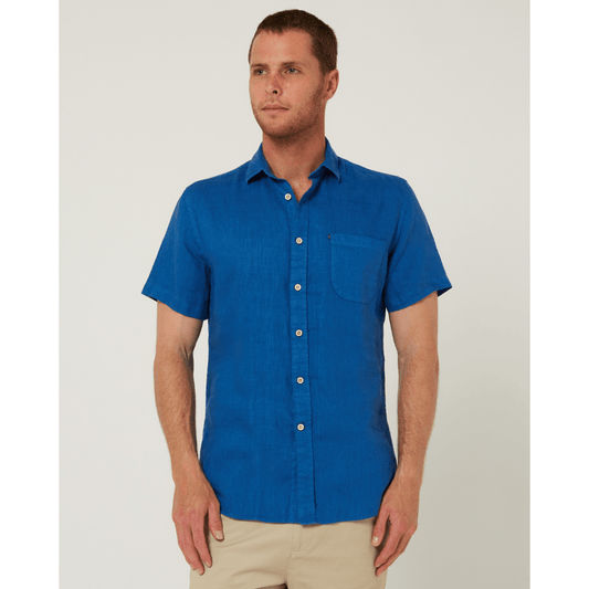 Model wearing men's Pilbara Collection by Ritemate Workwear Classic Fit Short Sleeve Linen Shirt in deep blue with Windmill embroidery detail, available at Stewart's Menswear Mullumbimby.