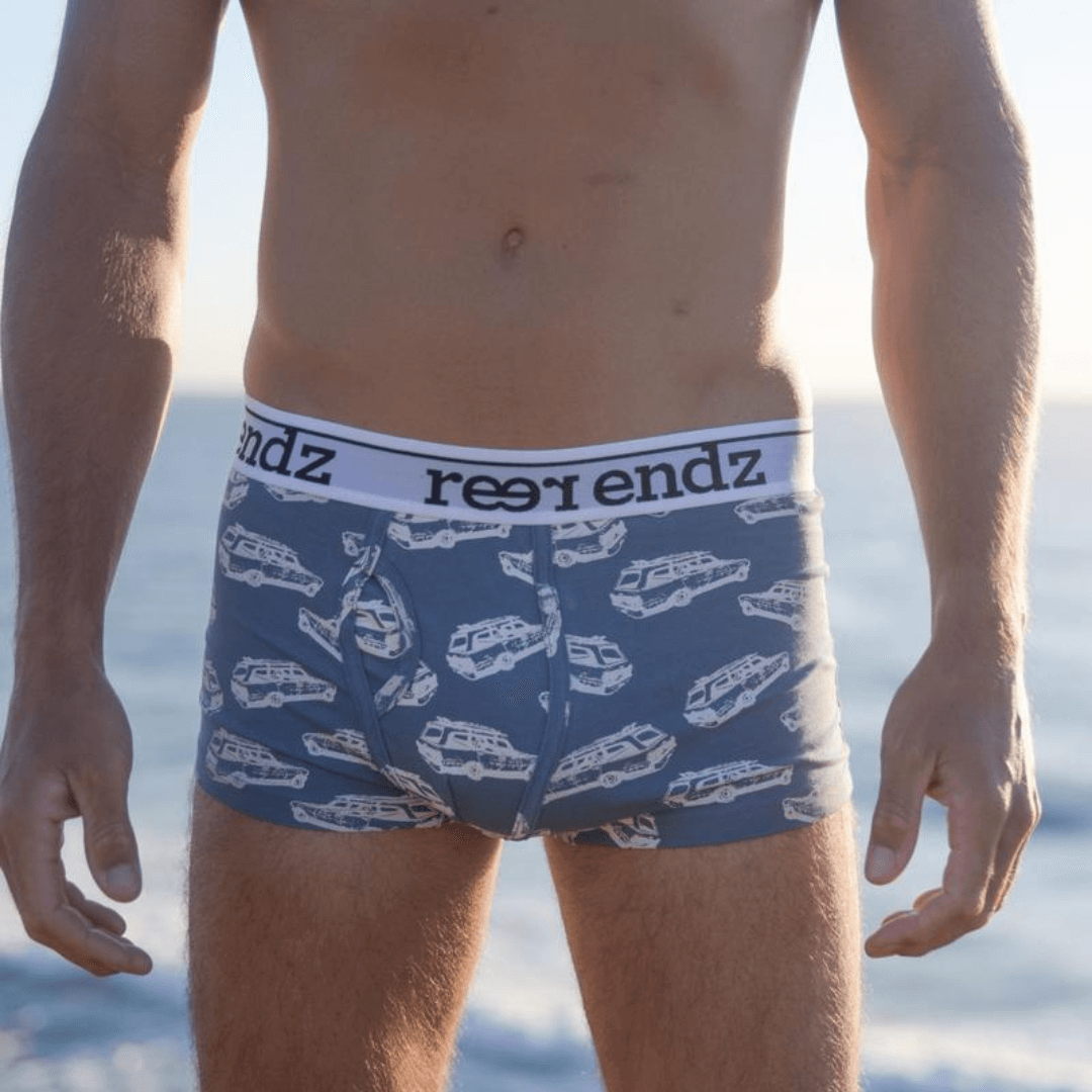 Stewarts Menswear Reer Endz Underwear. Made from Organic Cotton. Photo shows model wearing Chasing Waves print trunks. Light blue trunks with station wagon car print. Front View.
