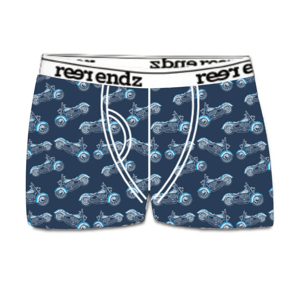 A pair of men's boxer briefs featuring an allover pattern of blue and white motorcycles on a dark navy background, with a white waistband printed with the brand name 'reer endz'. Reer Endz organic cotton underwear (Liv for the ride) available from Stewart's Menswear in Mullumbimby.