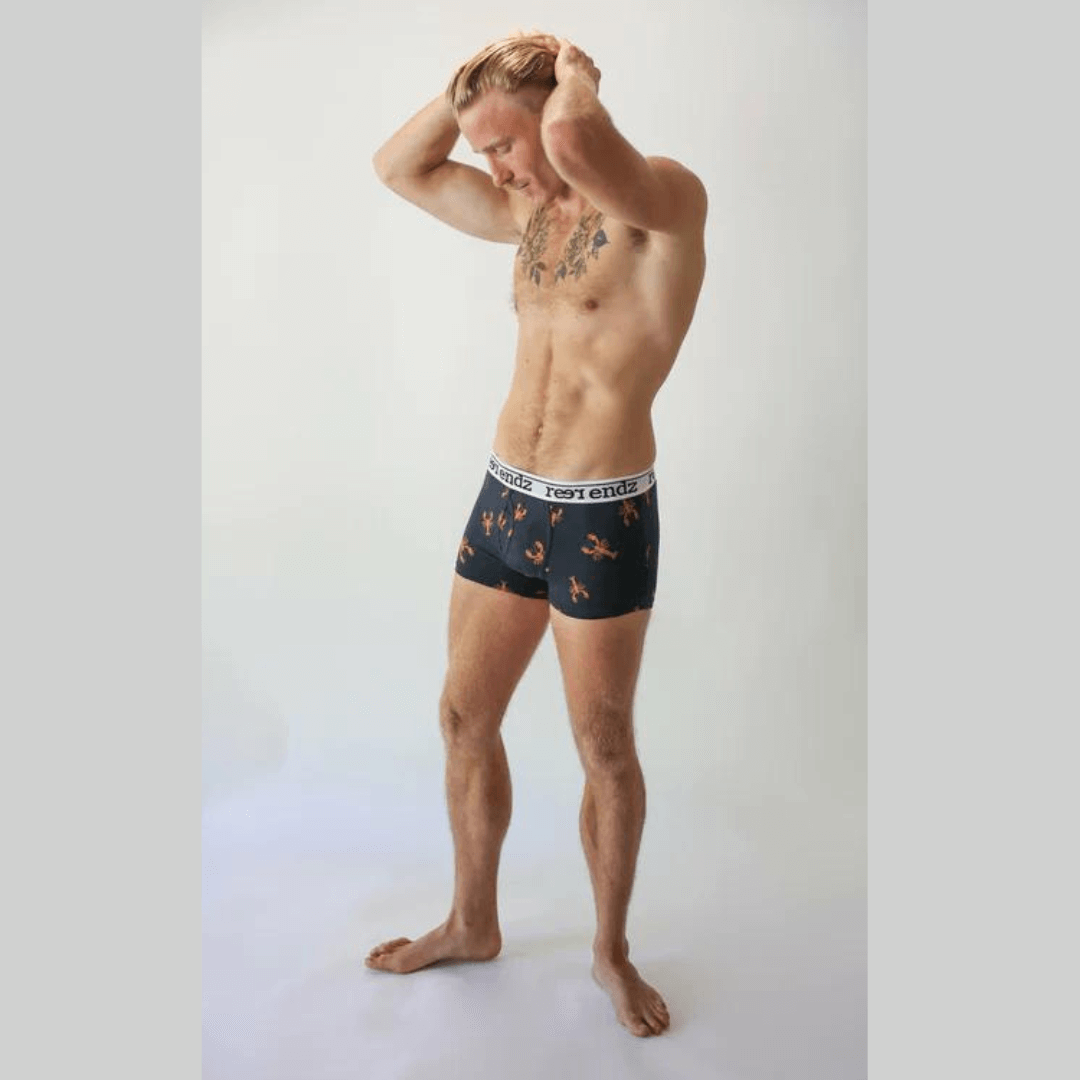 Stewarts Menswear Reer Endz underwear. Made from organic cotton. Photo shows model wearing snapper print trunks. Navy trunks with lobster print.