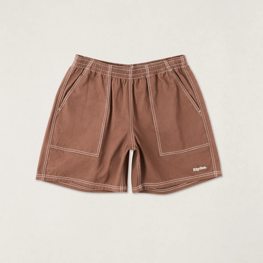 Flat-lay of Rhythm Contrast Stitch Jam shorts in chocolate brown with white contrast stitching.