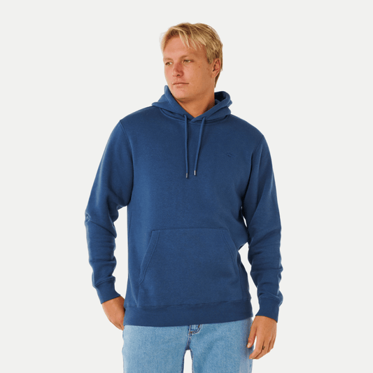 Man wearing a blue hoodie on a white background. Front view of Rip Curl Classic Surf Hoodie in light navy available from Stewart's Menswear, Mullumbimby.