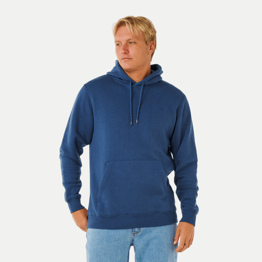 Model wearing Rip Curl Classic Surf Hoodie in light navy. Rip Curl Classic Surf Hoodie and Trackpant bundle available at Stewart's Menswear Mullumbimby — 2 for $140 with free postage.