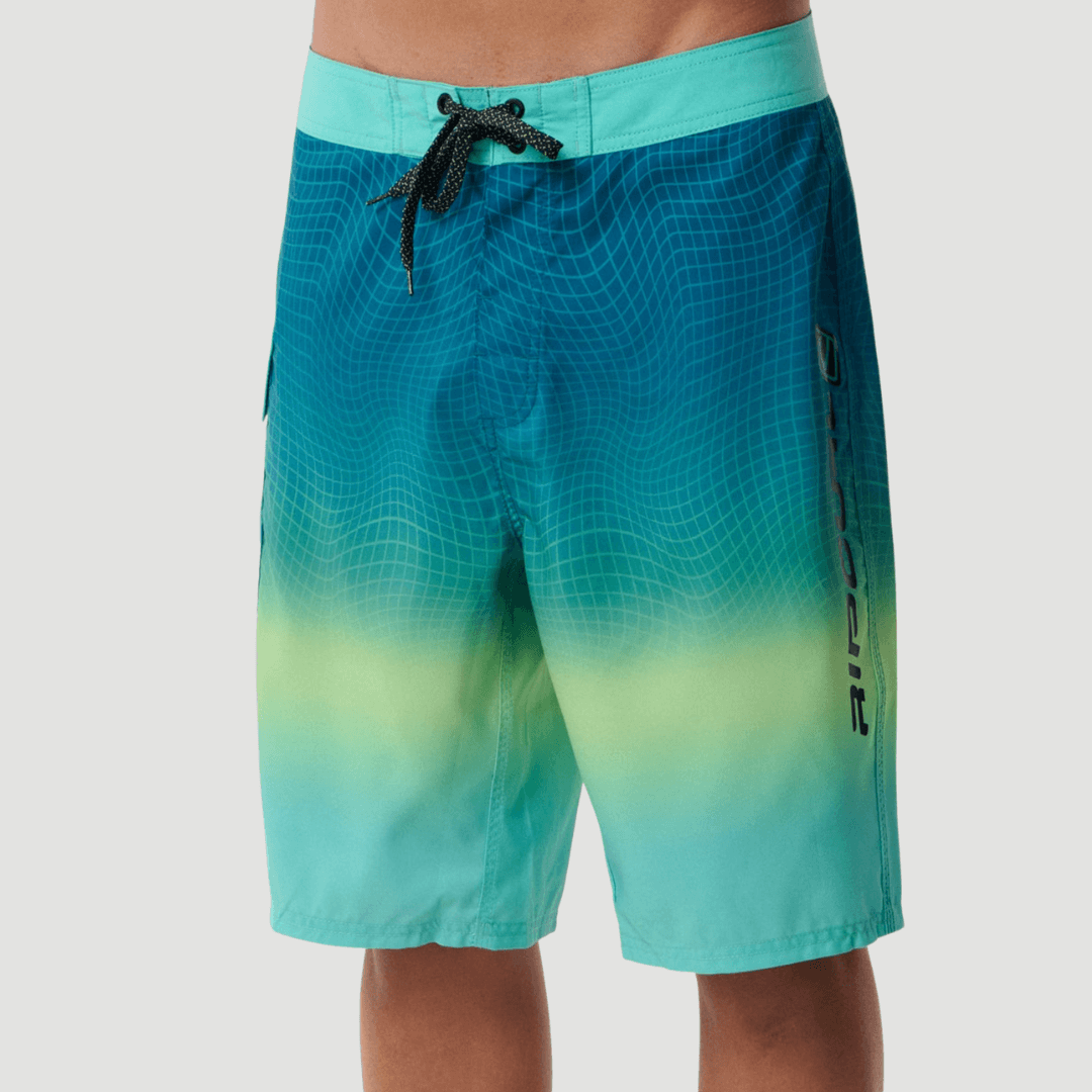 Front View of model wearing Rip Curl Shock Wave Boardshort Blue/Green available at Stewart’s Menswear Mullumbimby. Men’s quick-dry DWR surf shorts with side pocket.