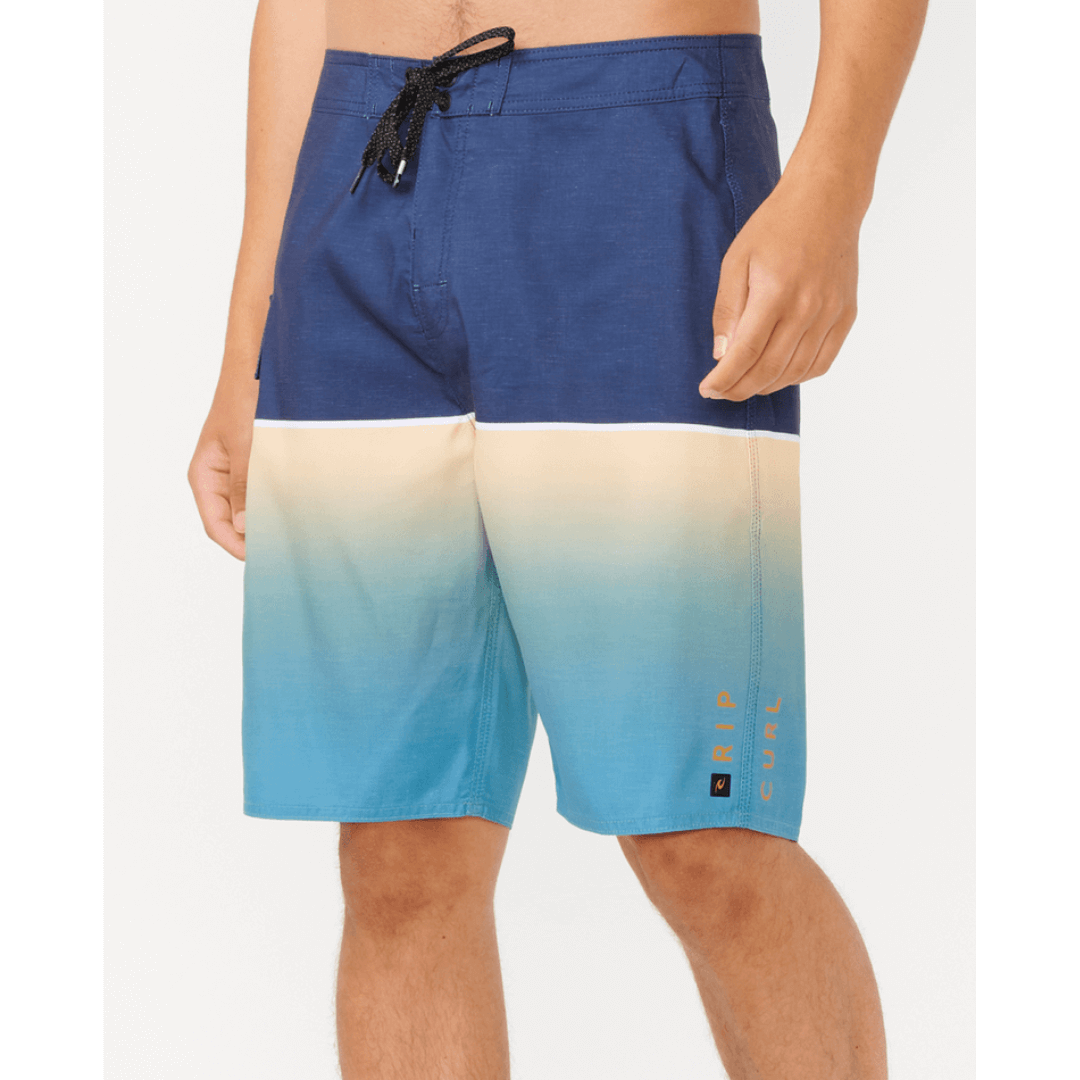 Stewart's Menswear Rip Curl Dawn Patrol Boardshorts. Navy top half with gradient blue bottom half. Photo shows close up front view of model wearing Rip Curl Dawn Patrol boardshorts. Colour is called Ocean.