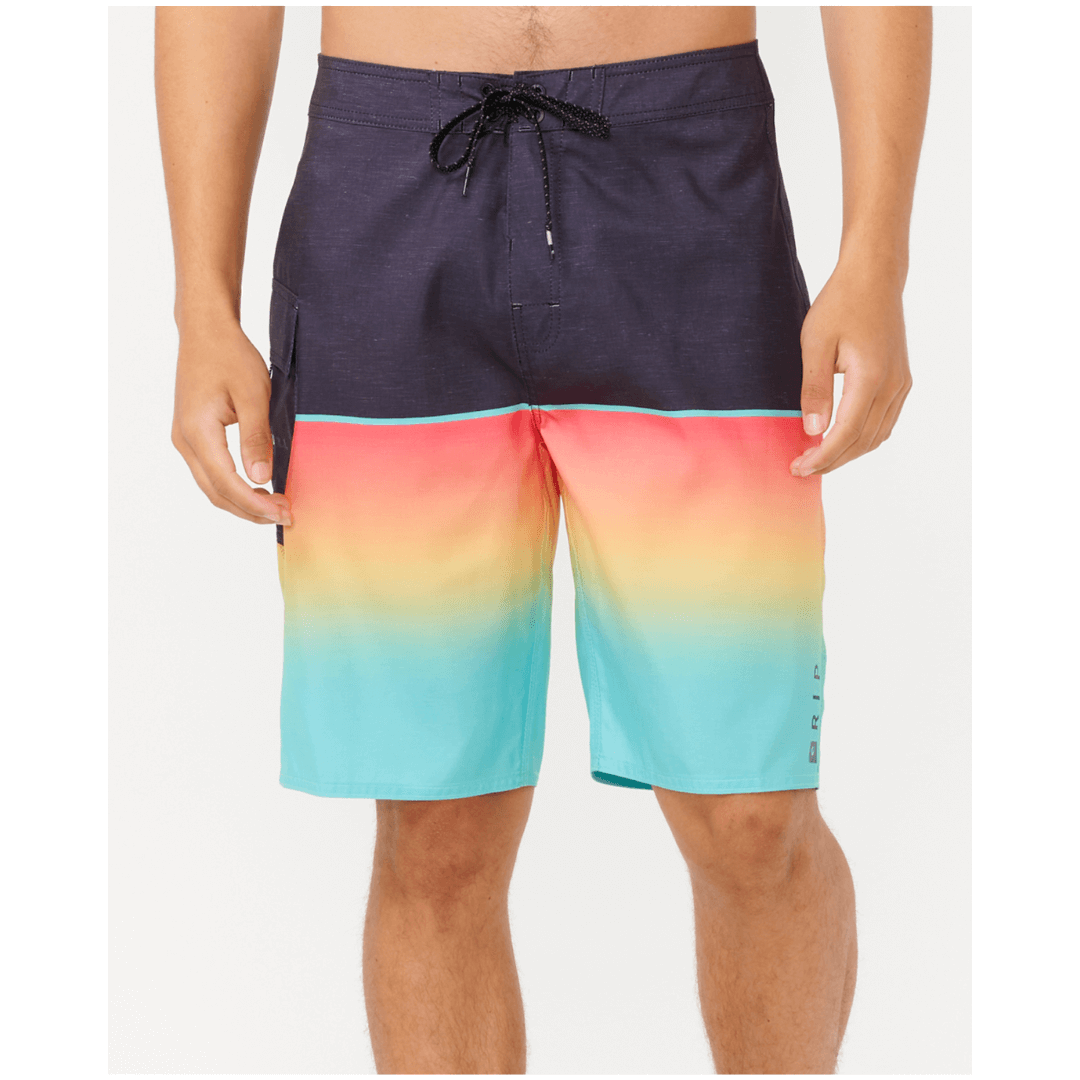 Stewart's Menswear Rip Curl Dawn Patrol Boardshorts. Black top half with gradient red/blue bottom half. Photo shows close up front view of model wearing Rip Curl Dawn Patrol boardshorts. Colour is called Washed Red.