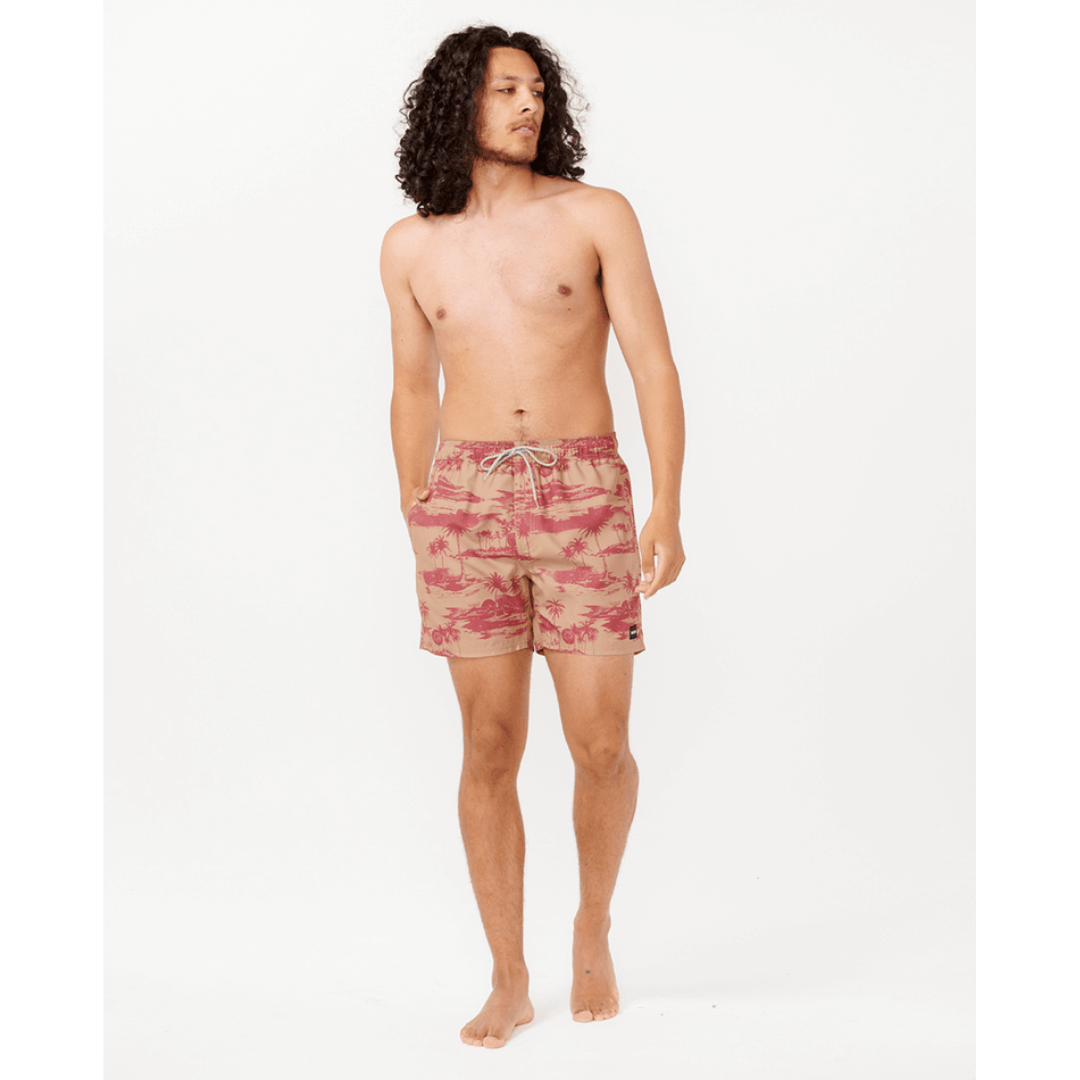 Stewarts Menswear Rip Curl Dreamers Volley Short. Colour is apple butter, a beige base with red island/palm tree print all over. Photo shows front view of model wearing Rip Curl Dreamers Volley Short.