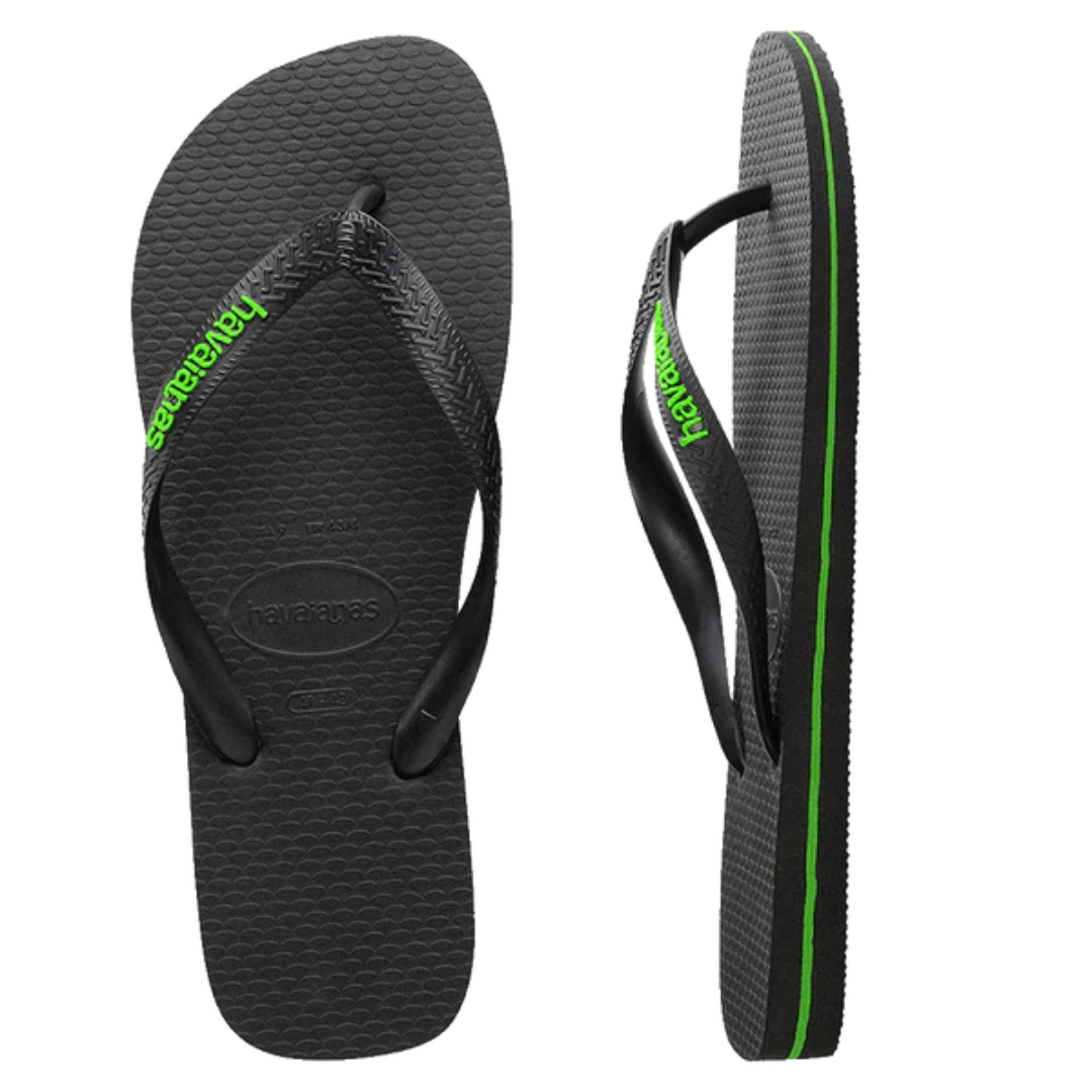 Stewarts Menswear Havaianas Rubber logo black green neon. The top view of a pair of Havaiana Thongs. Black footbed with black strap. Strap has raised rubber Havaiana logo coloured neon green.