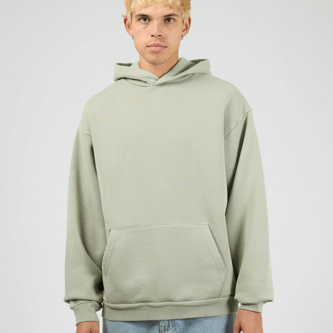 Front View of sage coloured Silent Theory Box Hoodie with hood and kangaroo pocket, available at Stewart’s Menswear Mullumbimby.