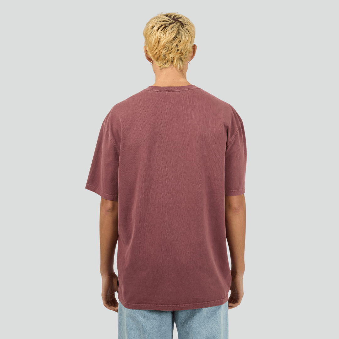 Back view of model wearing burgundy Silent Theory Essential Tee available at Stewart’s Menswear Mullumbimby. Men’s relaxed fit 100% cotton tee with crew neck and short sleeves.