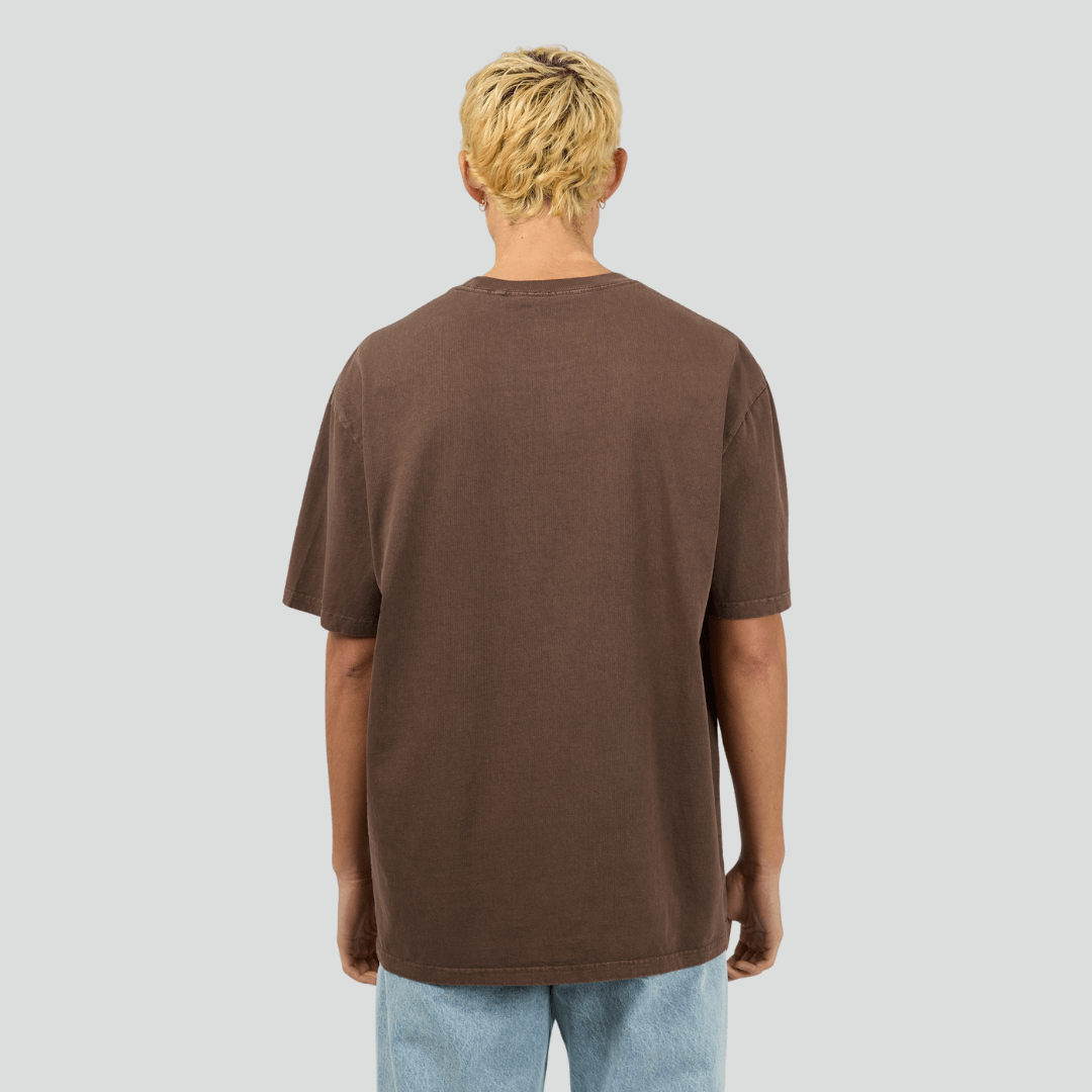 Back view of model wearing chocolate Silent Theory Essential Tee available at Stewart’s Menswear Mullumbimby. Men’s relaxed fit 100% cotton tee with crew neck and short sleeves.