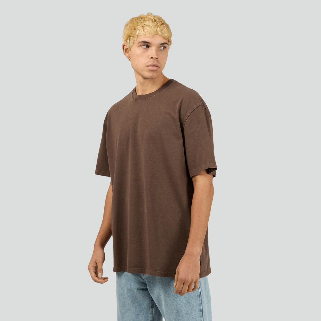 Front view of model wearing chocolate Silent Theory Essential Tee available at Stewart’s Menswear Mullumbimby. Men’s relaxed fit 100% cotton tee with crew neck and short sleeves.