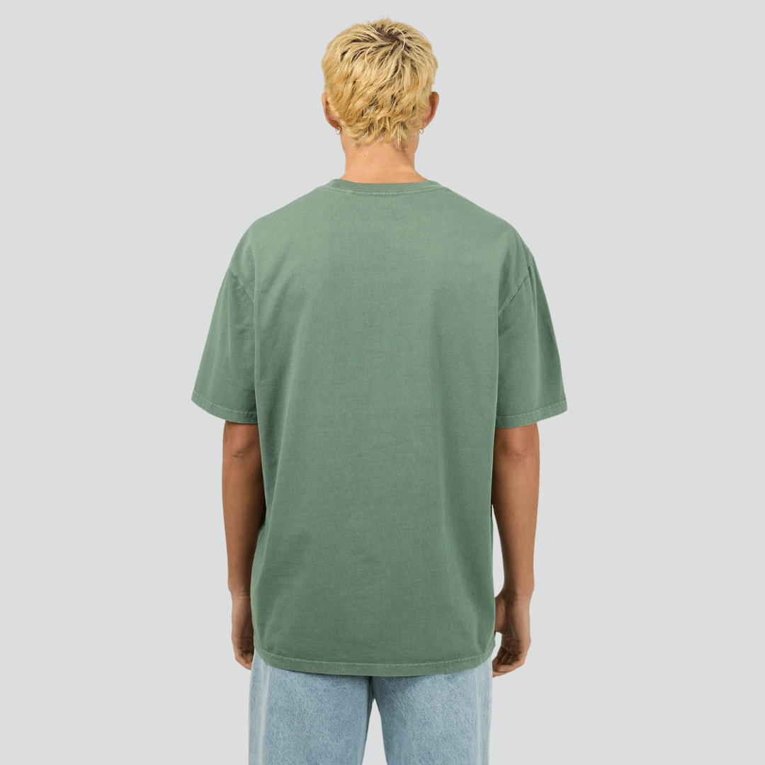 Back view of model wearing Green Silent Theory Essential Tee available at Stewart’s Menswear Mullumbimby. Men’s relaxed fit 100% cotton tee with crew neck and short sleeves.