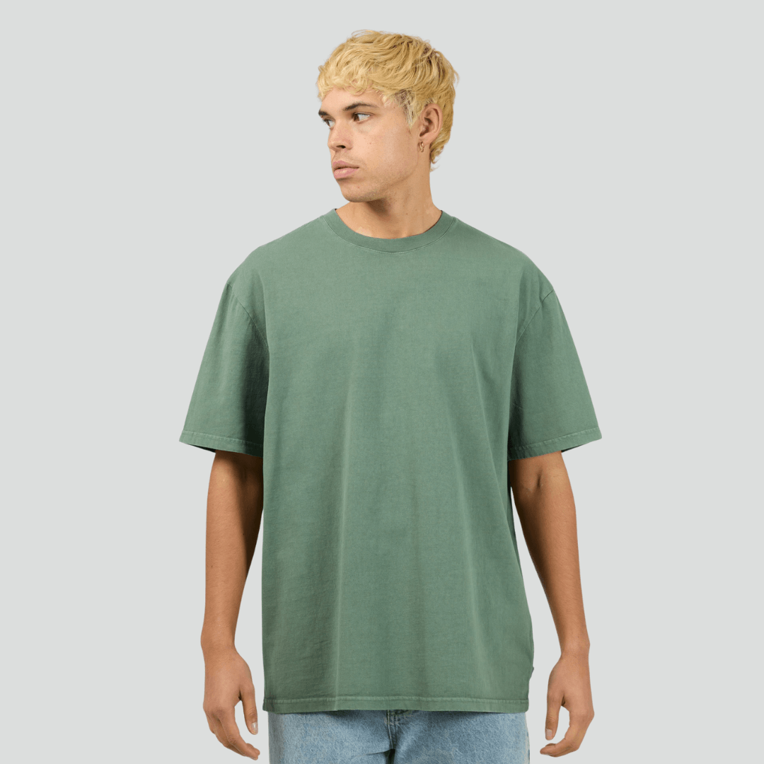 Front view of model wearing green Silent Theory Essential Tee available at Stewart’s Menswear Mullumbimby. Men’s relaxed fit 100% cotton tee with crew neck and short sleeves.