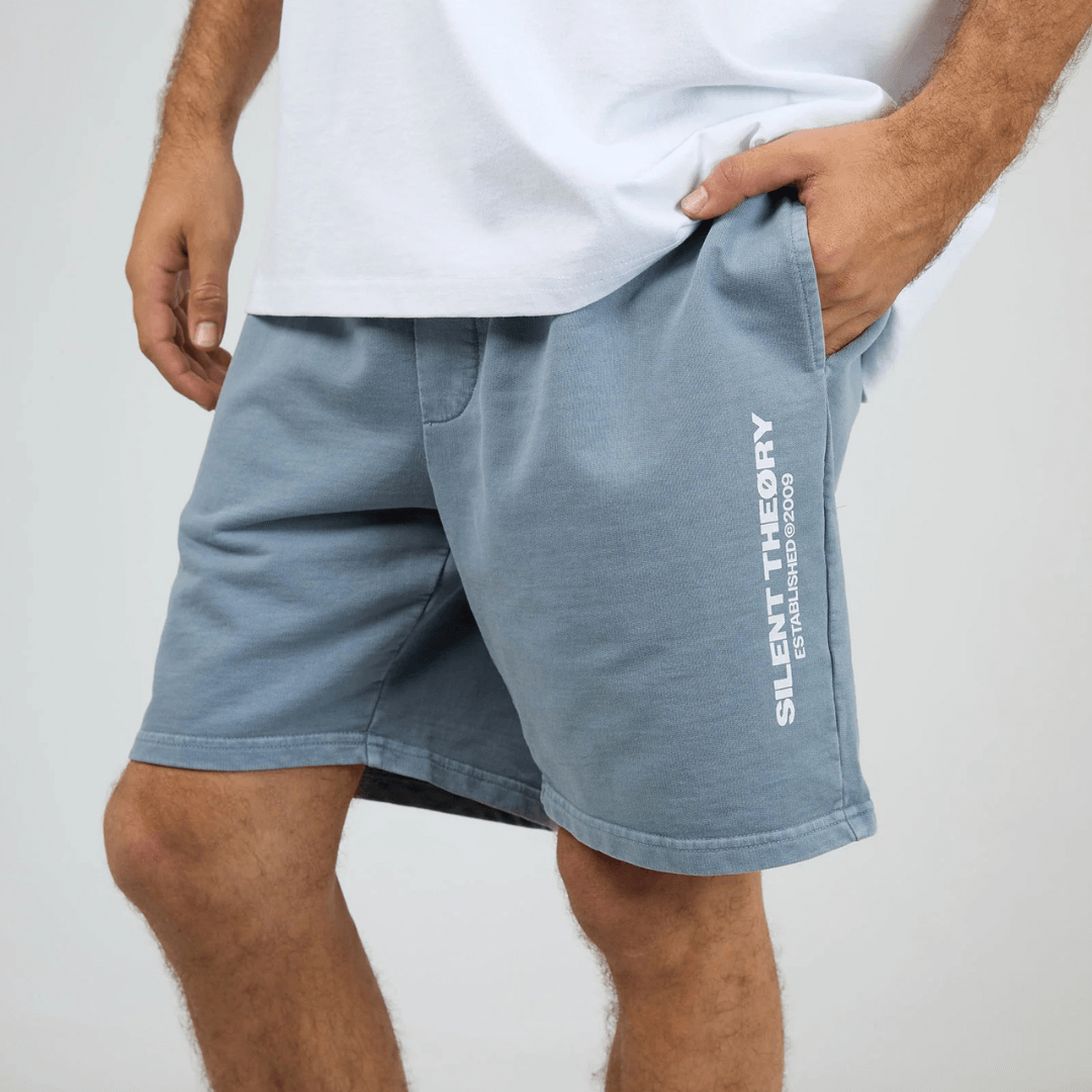 Front View of model wearing Silent Theory Essential Theory Short V2 available at Stewart’s Menswear Mullumbimby. Men’s unbrushed French terry cotton shorts with elastic waist and pockets. Light Blue.