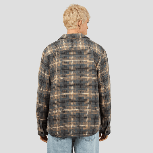 Back view of model wearing a plaid shirt over a white tee-shirt. Silent Theory Stature Overshirt Brown in classic check with chest pockets, available at Stewart’s Menswear Mullumbimby.