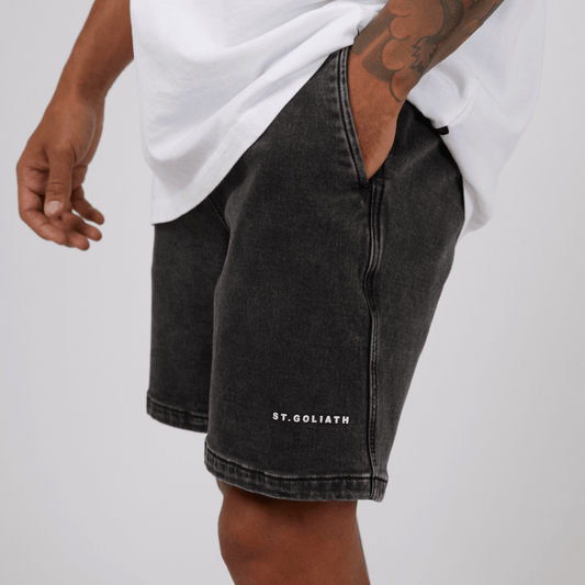 Stewart's Menswear, Mullumbimby. Model wearing St Goliath Fairhaven short in washed black. St. Goliath logo on leg.