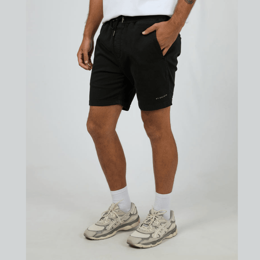 Stewart's Menswear, Mullumbimby. Model wearing St Goliath Fairhaven short in Black colour. St. Goliath logo on leg.