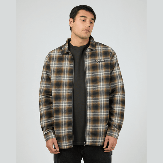 Model wearing St Goliath Floyd Shacket available at Stewart’s Menswear Mullumbimby. 100% cotton brushed check (navy, brown, white) shacket with quilted lining and zip-up front.