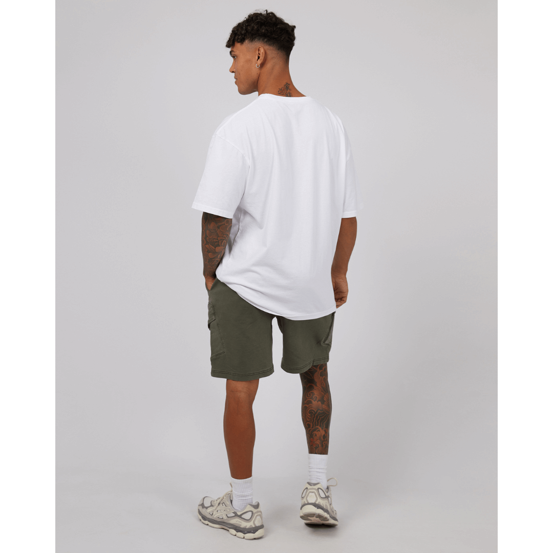 Stewarts Menswear St Goliath Gully Cargo shorts. The inset cargo pockets, waist band, and side pockets make these hybrid denim shorts a must-have for any adventure. Photo shows back view of model wearing St Goliath Gully Cargo Short. Colour is Khaki