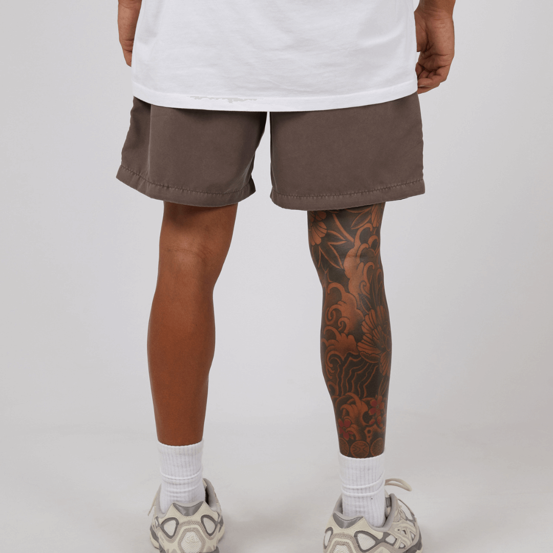 Stewarts Menswear St Goliath Illusion short. Made from 100% recycled material, Its faded look adds a touch of trendiness while the quick dry micro fibre material ensures comfort. Colour is Taupe. Image shows back view of model wearing St Goliath Illusion shorts.